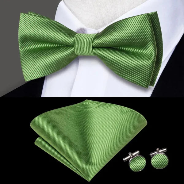 green bow ties with matching cuff links and pocket square