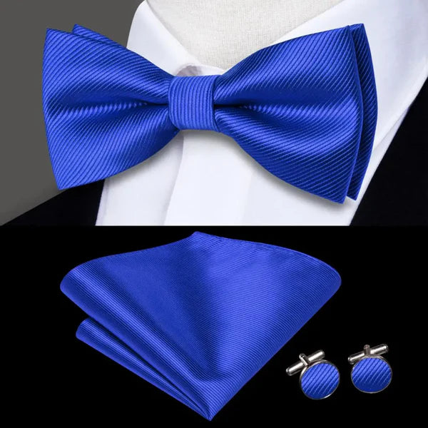 blue bow tie with matching cuff links and pocket square