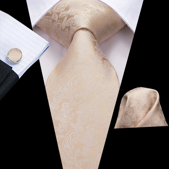 cream color paisley tie with cuff links and pocket square