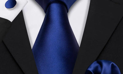 plain dark blue tie with cuff links and pocket square