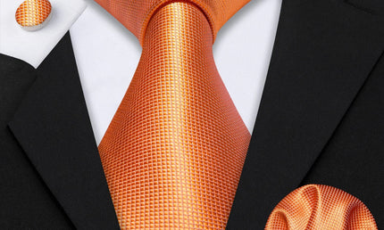 plain orange tie with matching cuff links and pocket square